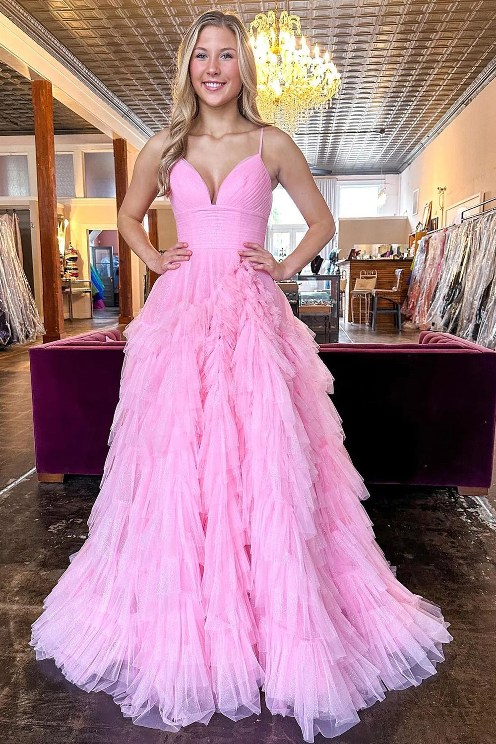 Pink long prom dress with spaghetti straps and ruffles in an A-line silhouette