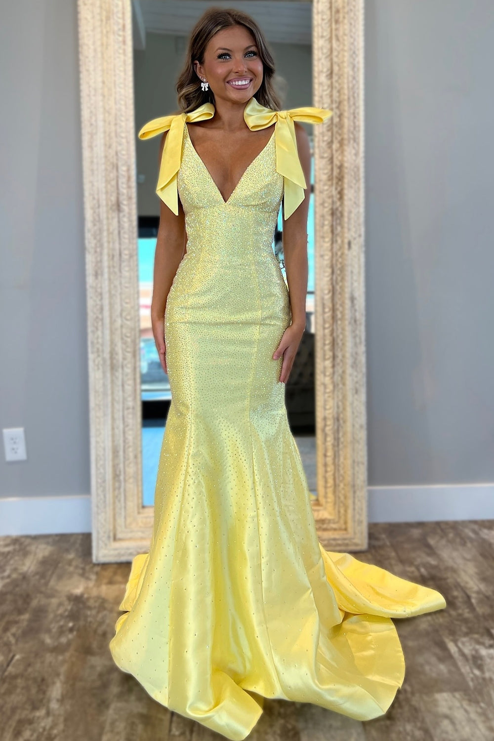 Yellow Beaded Mermaid Prom Dress with Glitter and Bows in a Deep V-Neck